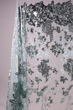 The image is a collage of various textures and patterns, including a metallic, textured surface with a mix of black, gray, and white elements.