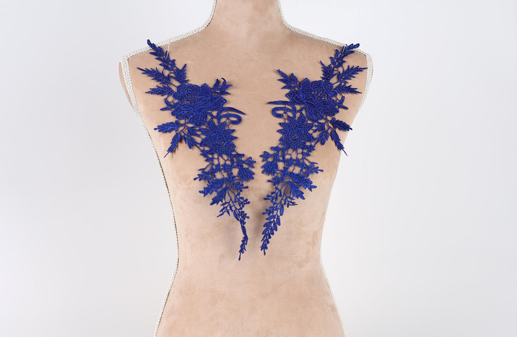 A mannequin with blue floral embroidery on its bust area.