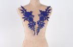 A mannequin with blue floral embroidery on its bust area.