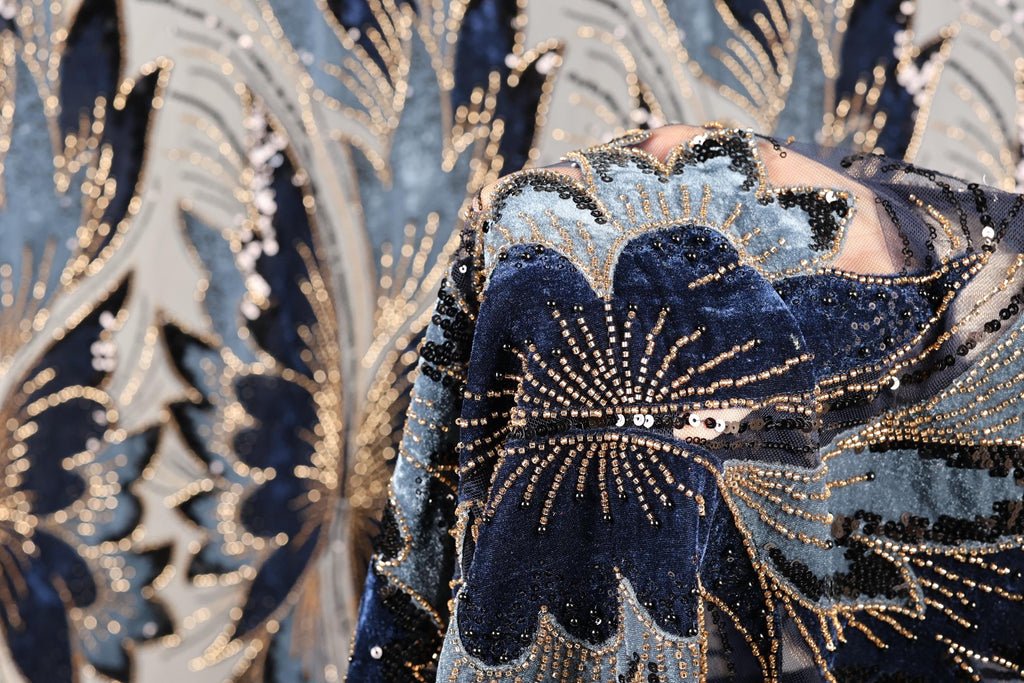 a close-up view of a fabric with a floral pattern, showcasing intricate details and a rich, blue-toned color scheme.
