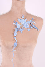 A mannequin with a floral embroidered patch on its shoulder.