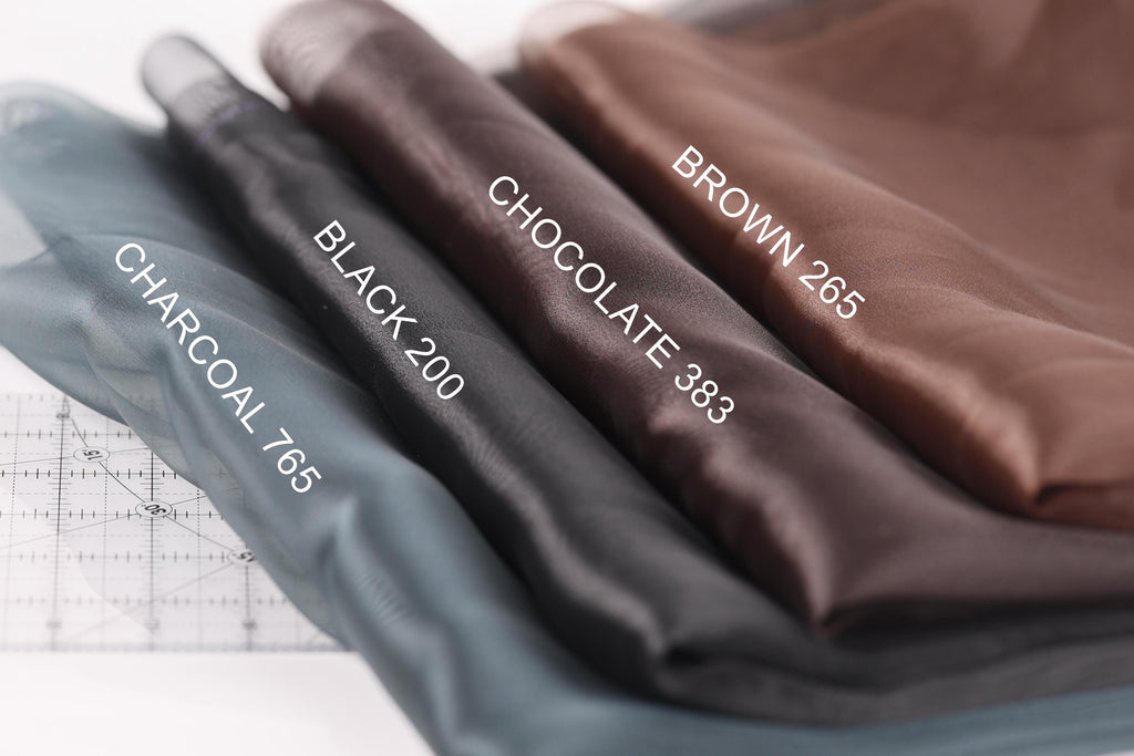 a close-up view of three different colored fabrics, each with a label indicating the color: black, brown, and gray.