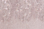 a background with a pink and white color scheme, adorned with a pattern of sequins and delicate flowers. The pattern appears to be a decorative textile or fabric, with the pink and white colors creating a visually appealing and harmonious design.
