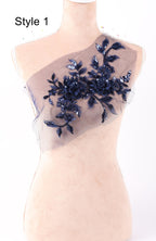 A mannequin with a decorative fabric piece featuring a floral pattern in navy blue and white colors.