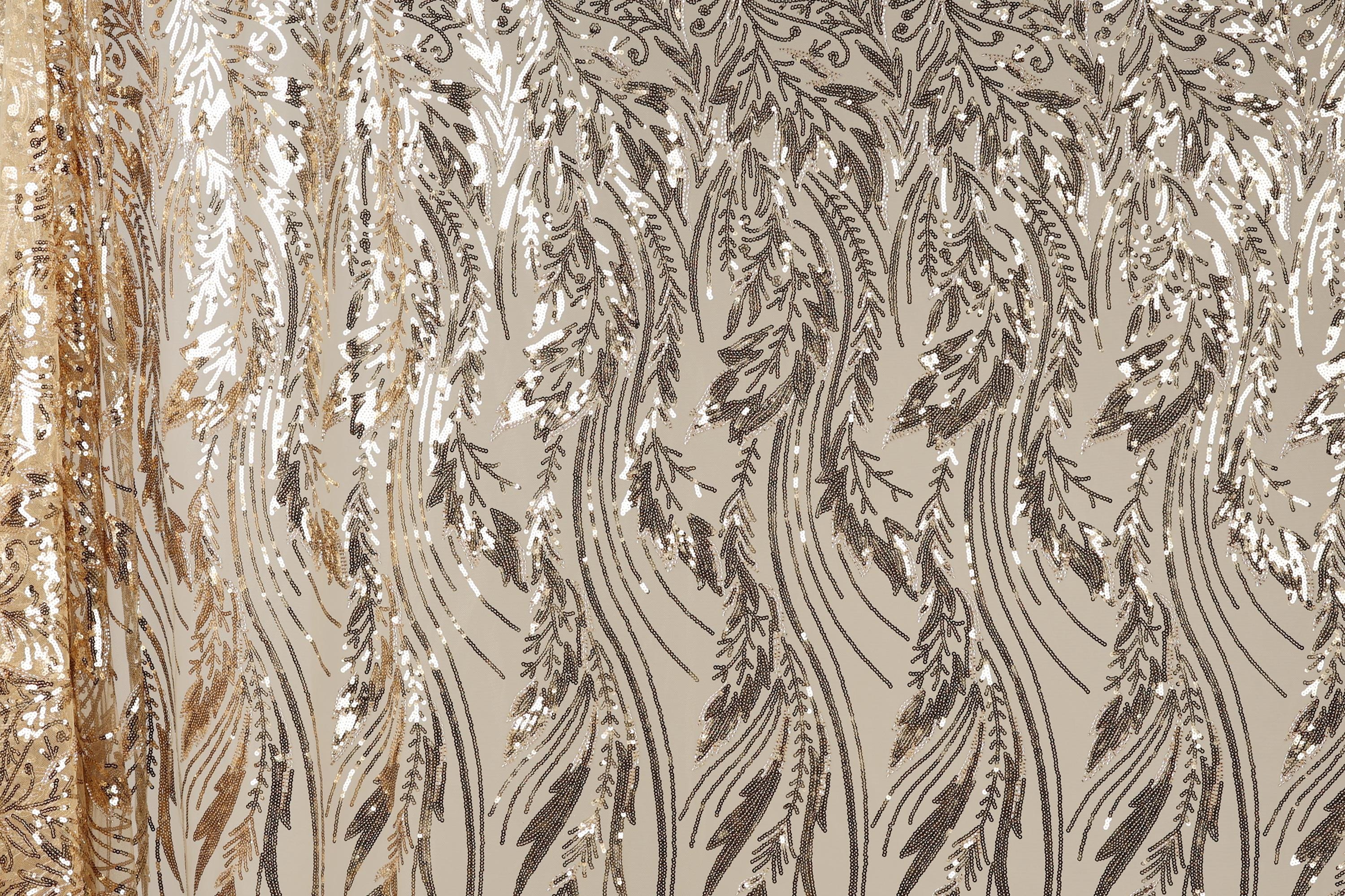 a close-up view of a fabric with a repeating pattern of sequin designs in shades of brown and gold. The pattern appears to be a floral or leaf-like design, with the sequins arranged in a way that creates a sense of movement and texture. The fabric has a shiny, metallic appearance, which adds to the overall visual appeal of the image.