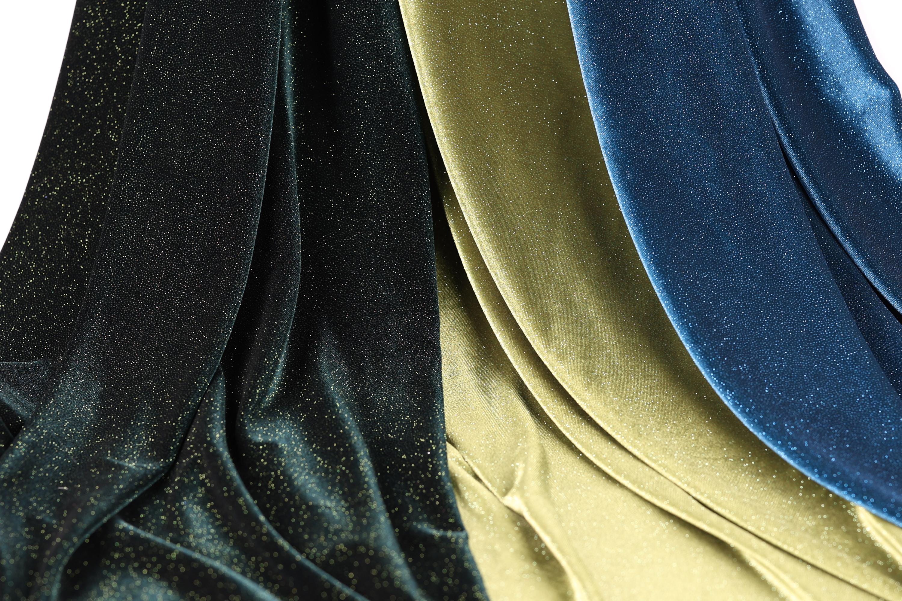 a close-up view of three different fabric swatches, each with a unique color and texture. The fabric swatches are arranged in a way that allows for a clear comparison of their appearance and characteristics.