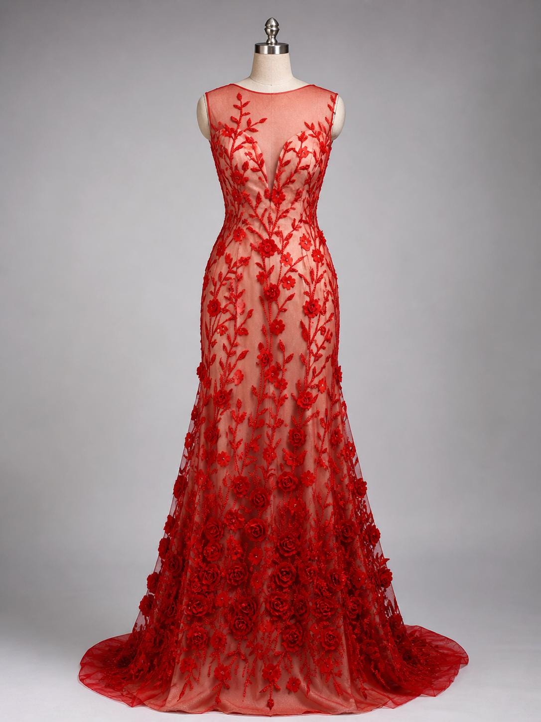 A red, floor-length dress with a sheer neckline and a long train, featuring a floral pattern on the bodice and skirt.