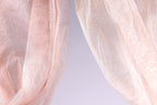 two pieces of fabric, one in a soft pink color and the other in a lighter shade of pink, with a subtle glittery texture.