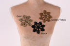 A mannequin torso with three different colored snowflake-shaped embellishments on it, labeled as gold, golden yellow, and black.