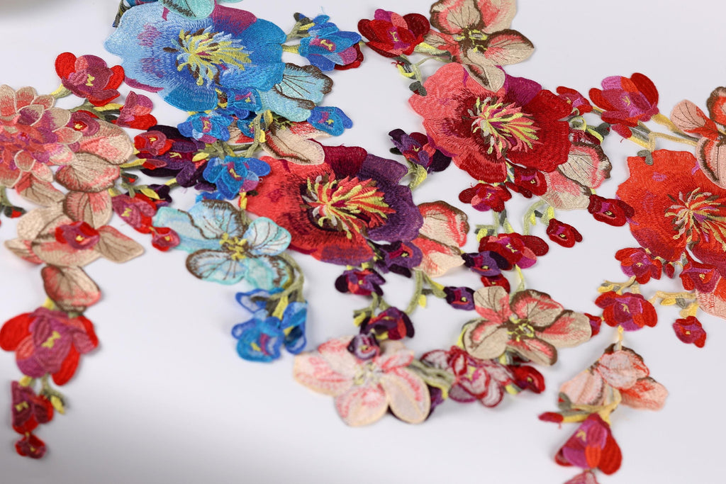 a vibrant display of colorful flowers, including red, pink, blue, and purple blooms, arranged in a visually appealing manner.