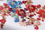 a vibrant display of colorful flowers, including red, pink, blue, and purple blooms, arranged in a visually appealing manner.