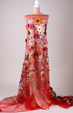 A mannequin wearing a long, red dress with a floral pattern.