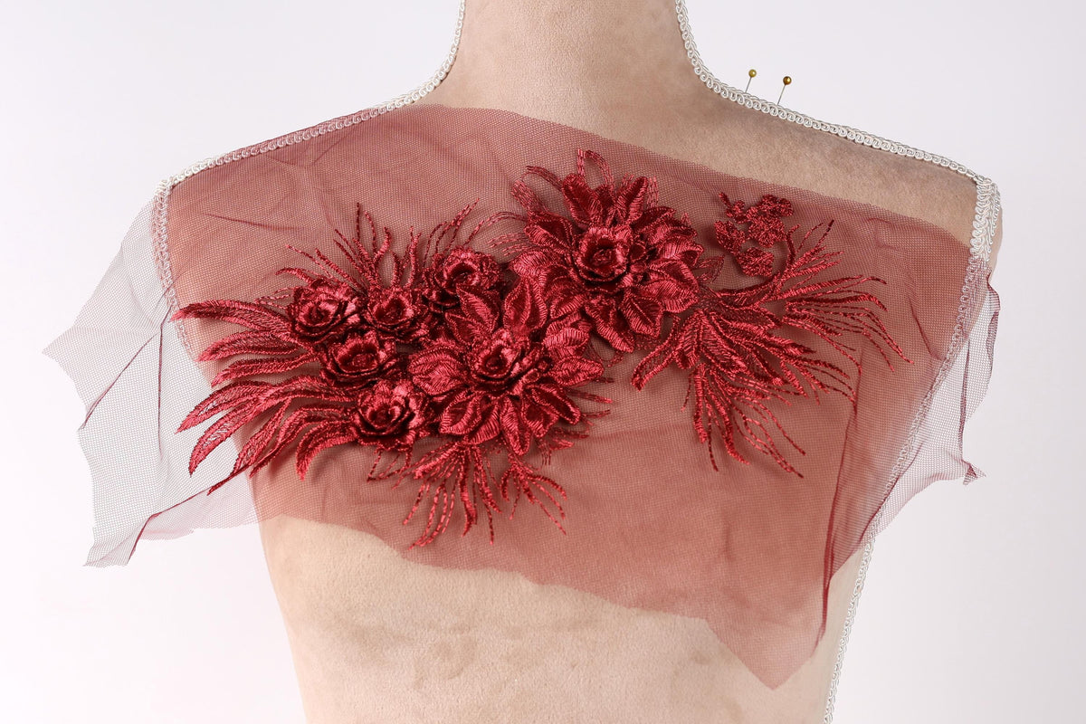 a mannequin with a red floral design on its shoulder.