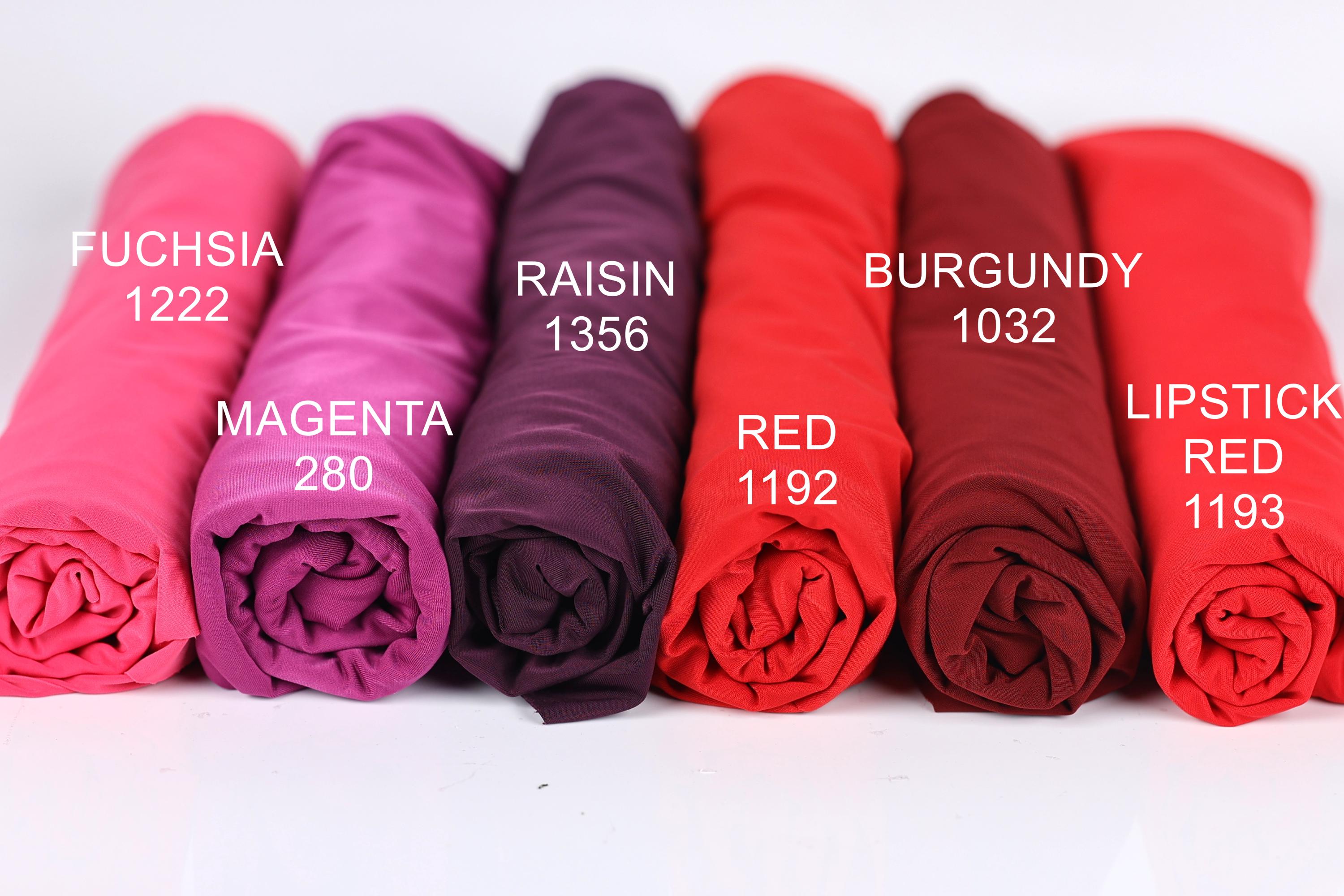 six rolled-up fabric swatches in various colors, including pink, purple, burgundy, magenta, red, and lipstick red.