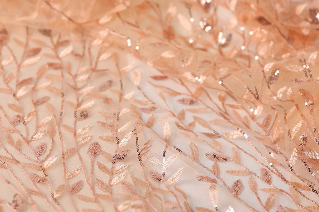 a close-up view of a fabric with a delicate, intricate pattern of leaves and branches, creating a soft, natural-looking texture.