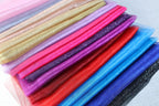 a stack of different colored cloths sitting on top of each other