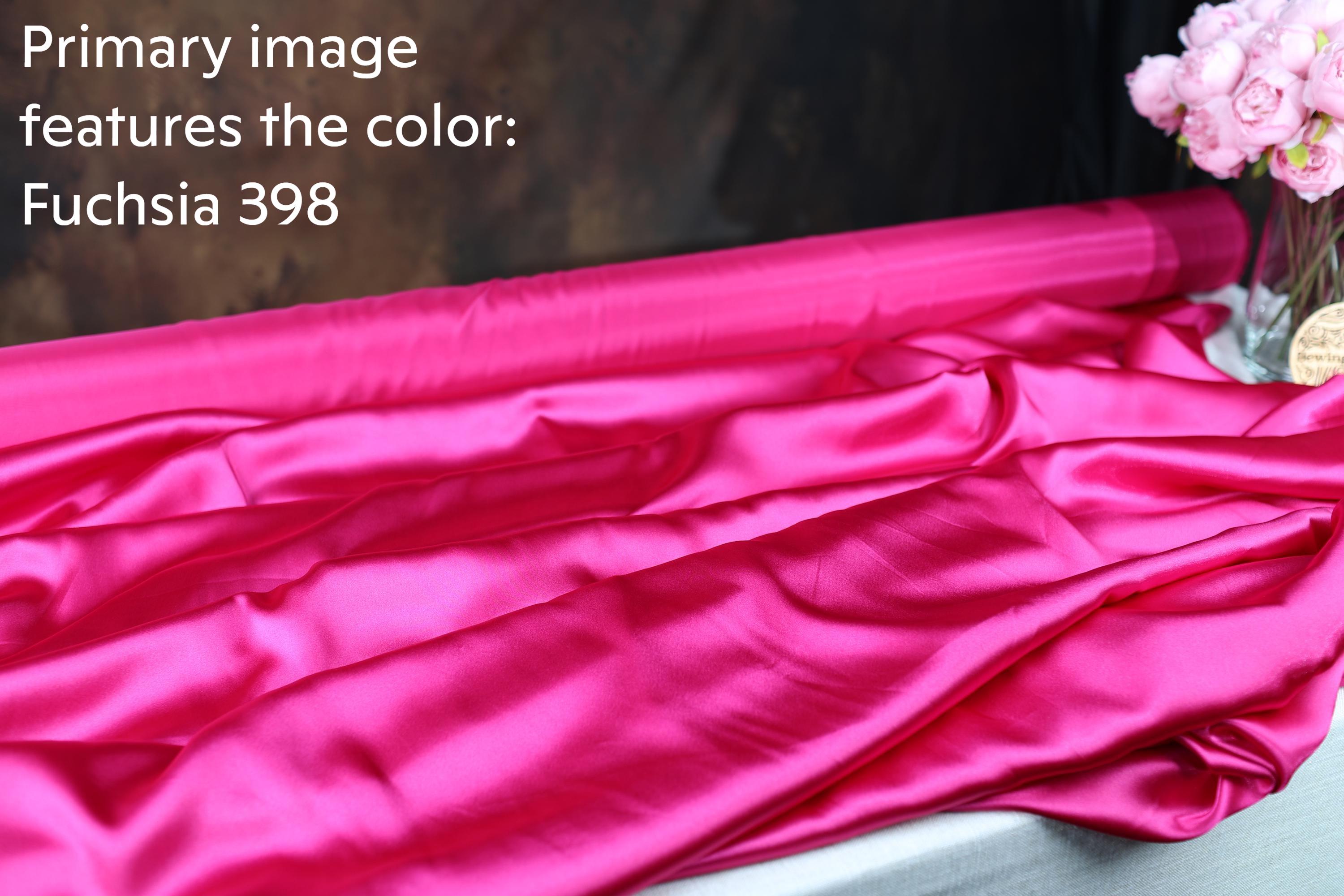 a roll of pink satin fabric with the text "Fuchsia 398" and a vase of pink flowers.