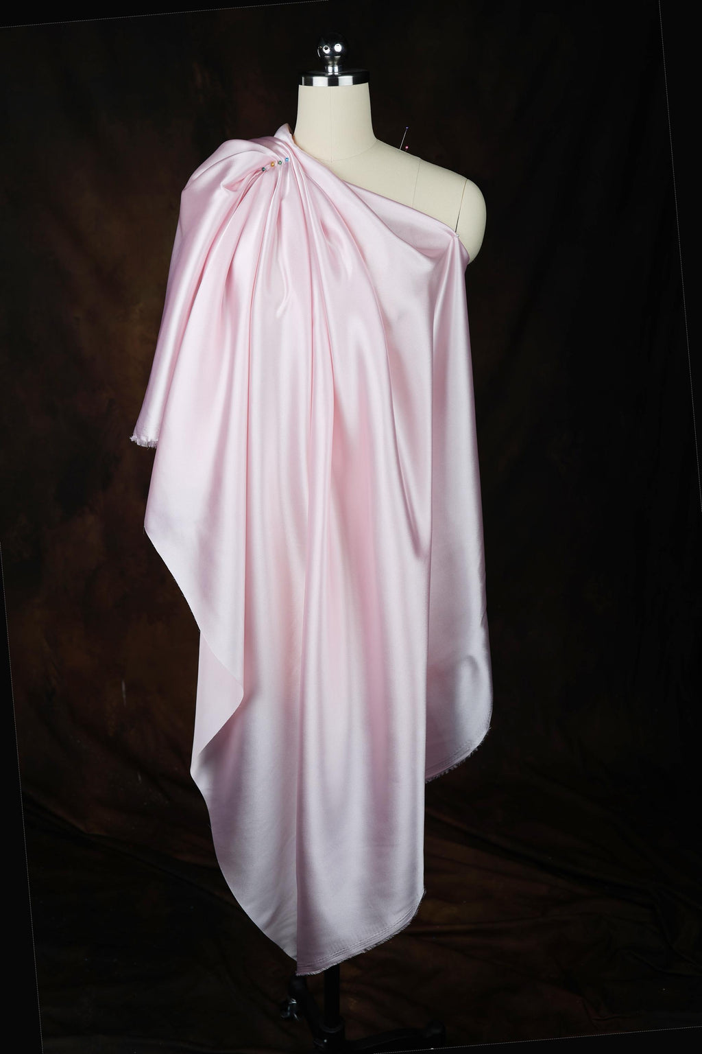 a dress on a mannequin on a black background