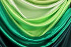 a close-up view of a fabric with a gradient of green and white colors, creating a visually appealing and textured appearance.