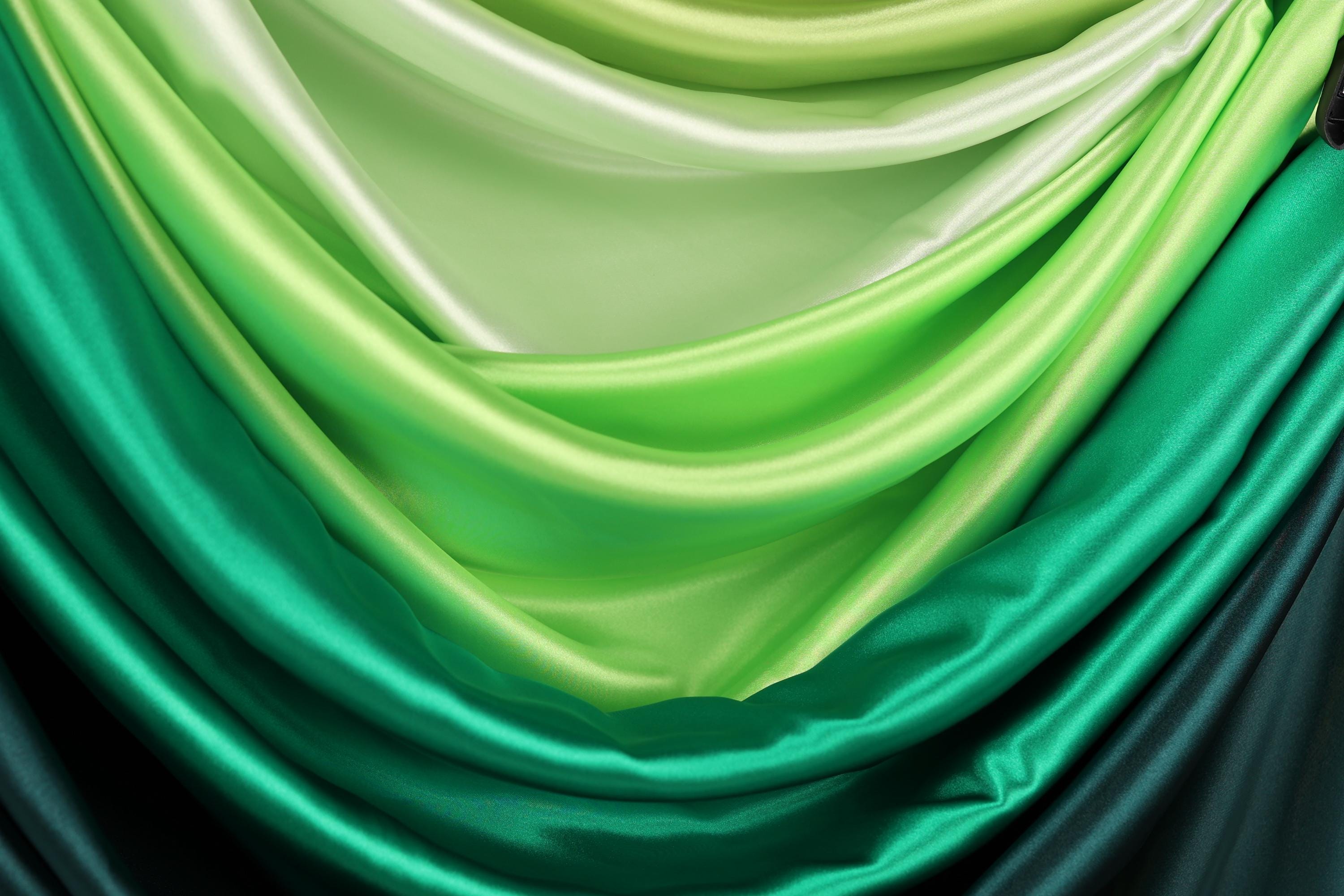 a close-up view of a fabric with a gradient of green and white colors, creating a visually appealing and textured appearance.