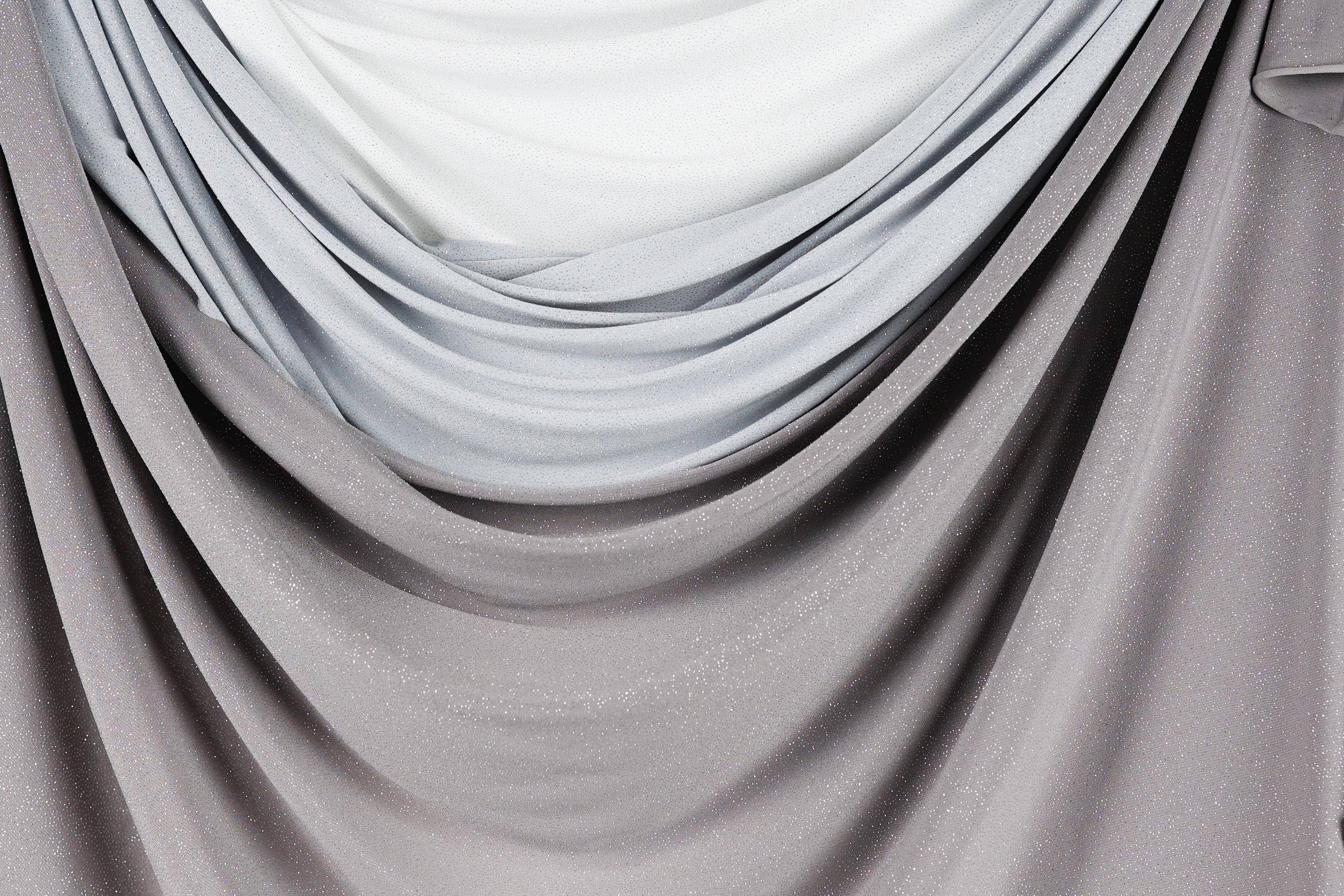 a close-up view of a fabric with a gradient of gray and white colors, creating a soft and flowing appearance.