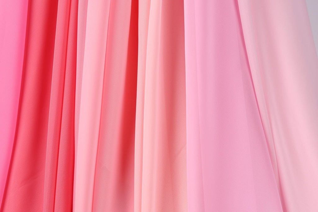 A close-up view of a collection of pink and red fabric panels, creating a visually striking and vibrant composition.