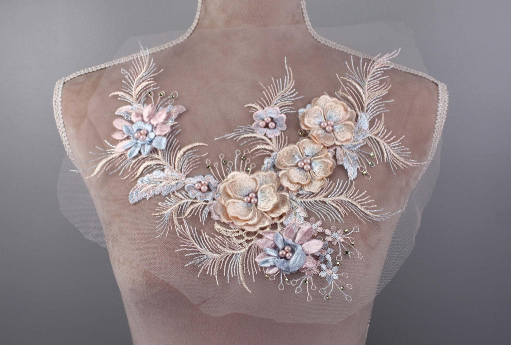 A mannequin torso with a delicate floral embroidery design on the bust area.