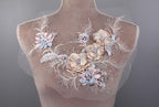 A mannequin torso with a delicate floral embroidery design on the bust area.