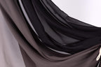 a close-up view of a fabric with a mix of black and gray colors, creating a textured and layered appearance.