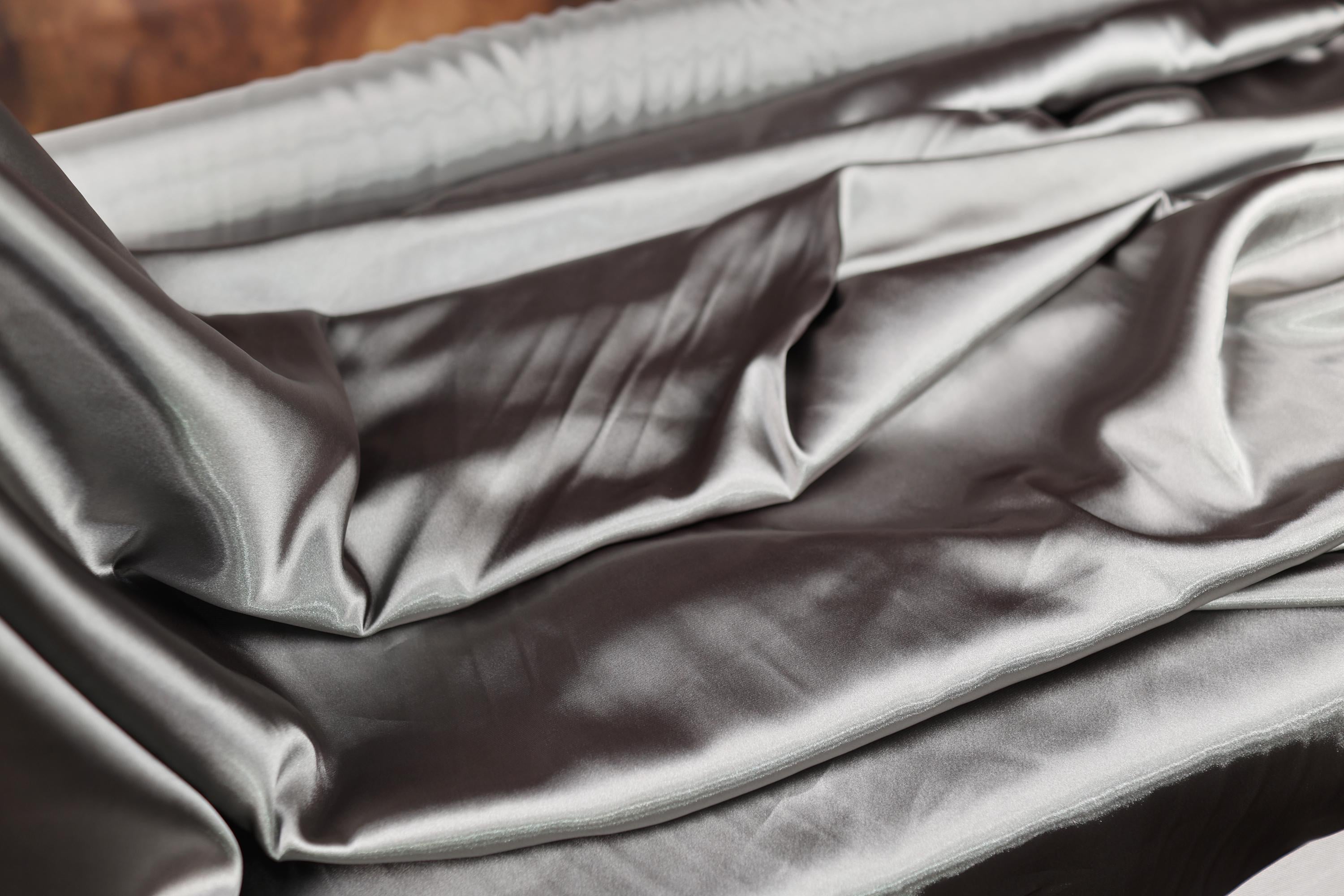 a close up of a bed with a sheet on top of it