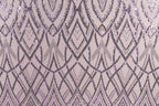 a repeating pattern of purple and black diamond shapes on a light pink background.