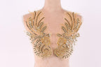 A mannequin torso with gold and beige sequined and beaded decorative pieces on the shoulders.