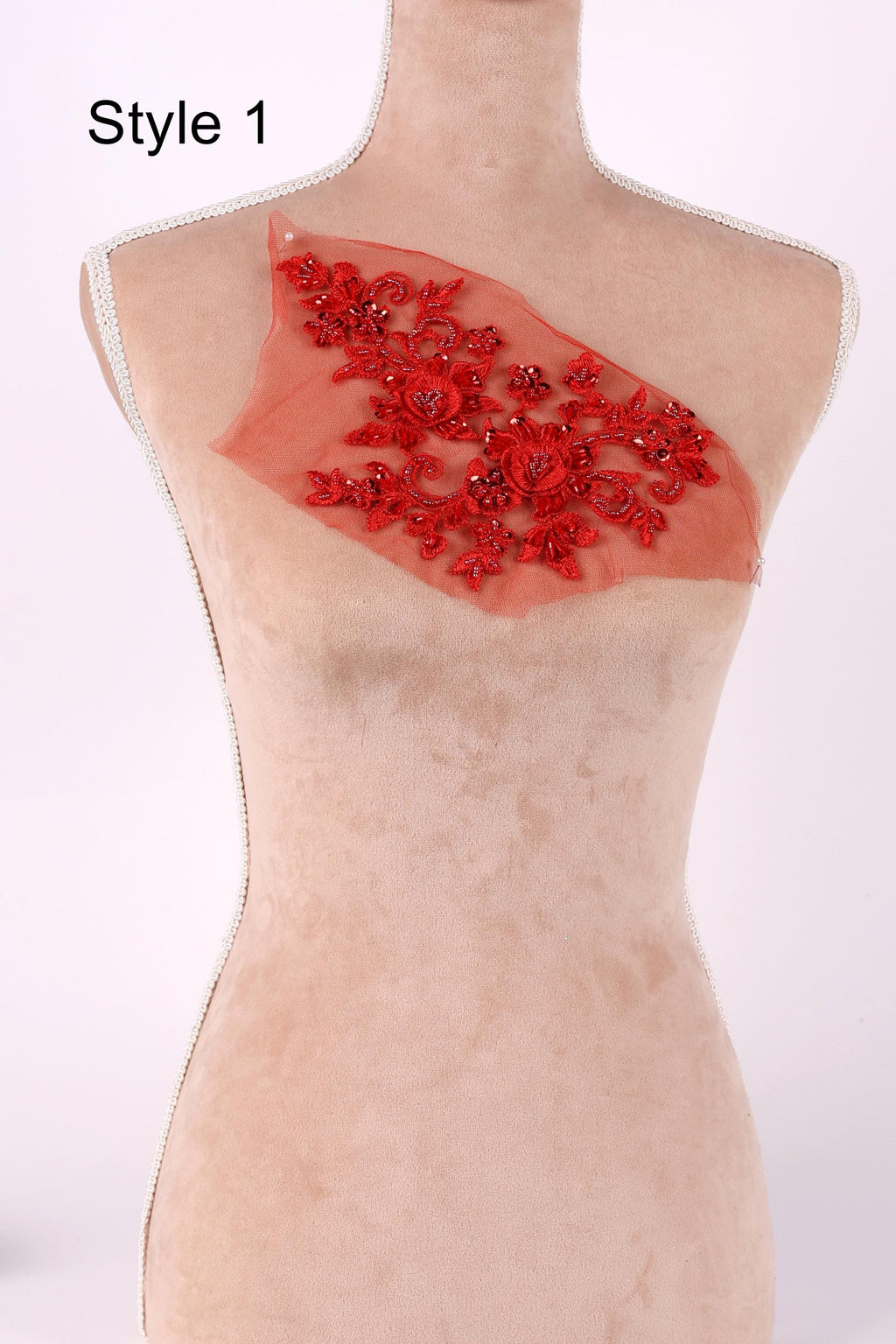A mannequin with a red floral embroidered on its chest.