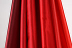 a close-up view of a red and black fabric, with the red fabric appearing more vibrant and the black fabric appearing slightly faded.