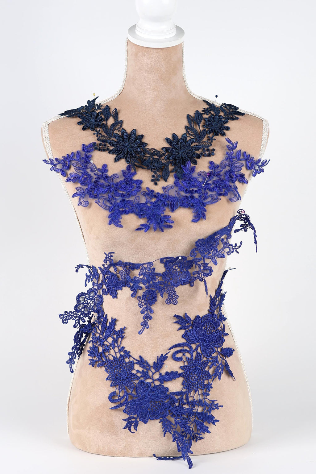 A mannequin wearing a dress with a floral pattern in shades of blue and black.