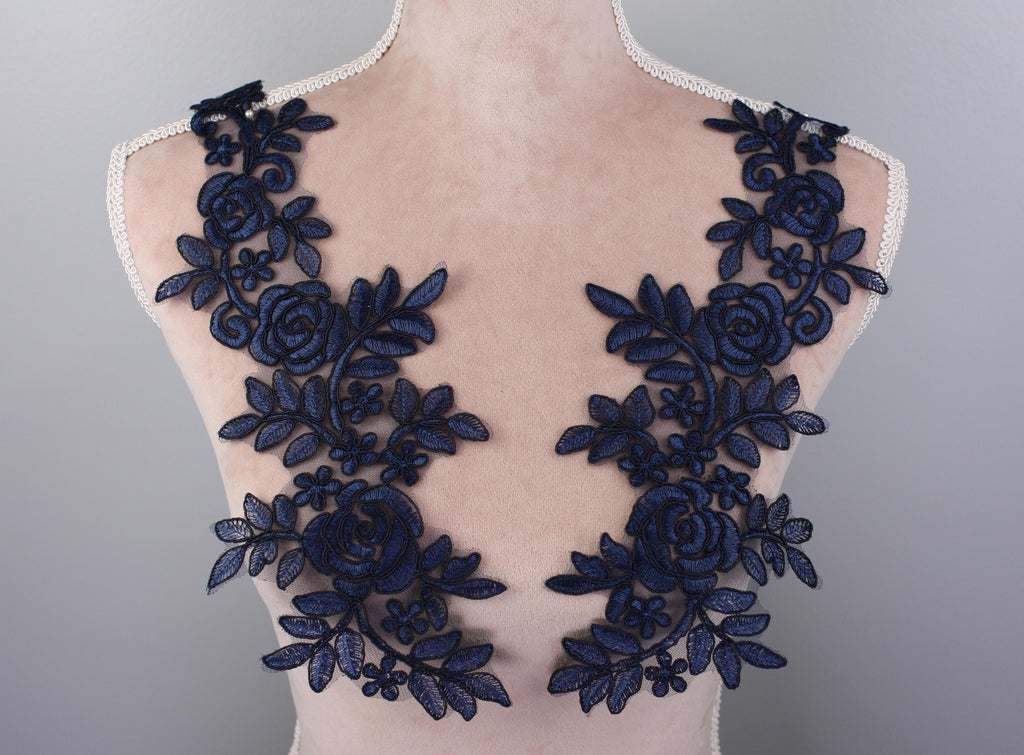 the back of a dress with blue flowers on it