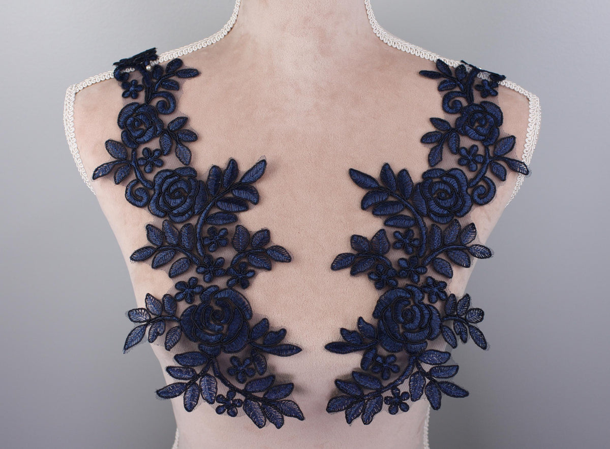 the back of a dress with blue flowers on it