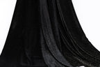 a close-up view of a black velvet fabric with a sparkly texture, creating a shiny and luxurious appearance.