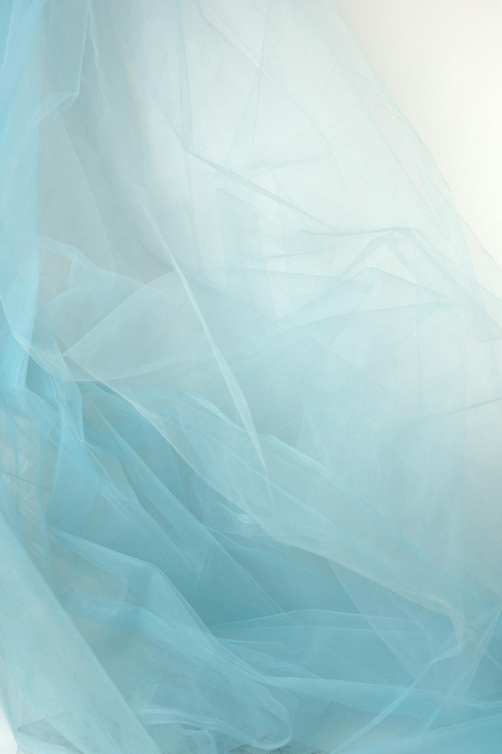The image is a close-up of a light blue, sheer fabric, with its delicate and flowing texture.