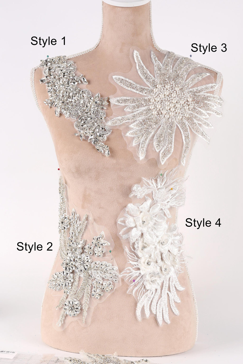 A mannequin with various decorative pieces of fabric and lace attached to its bust area, labeled with different styles.