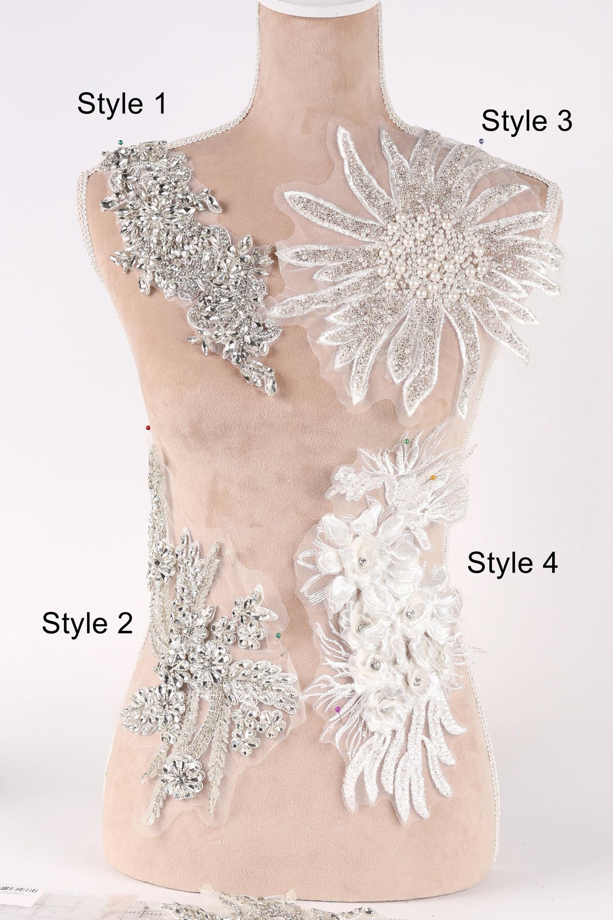 A mannequin with various decorative pieces of fabric and lace attached to its bust area, labeled with different styles.