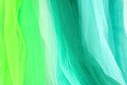 a close-up view of a piece of fabric with a vibrant mix of green and blue colors, creating a visually striking contrast.