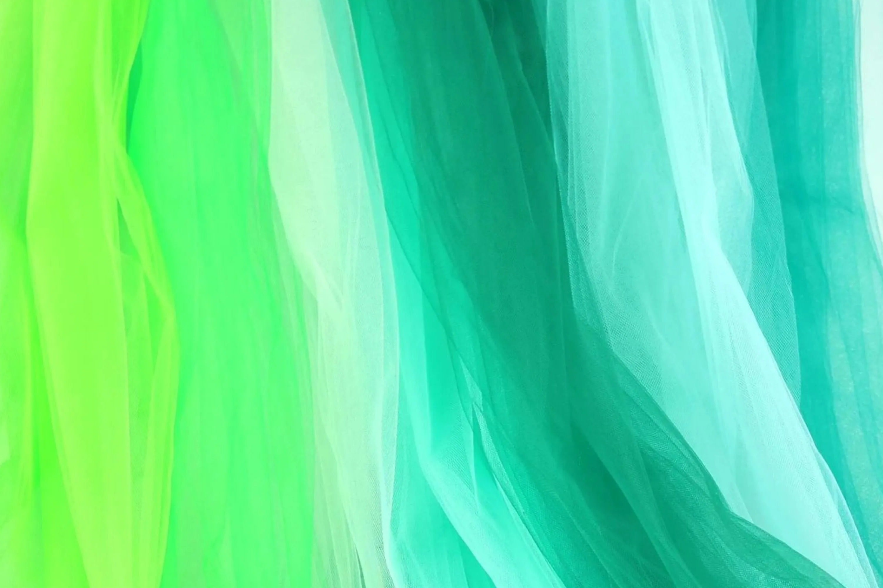 a close-up view of a piece of fabric with a vibrant mix of green and blue colors, creating a visually striking contrast.