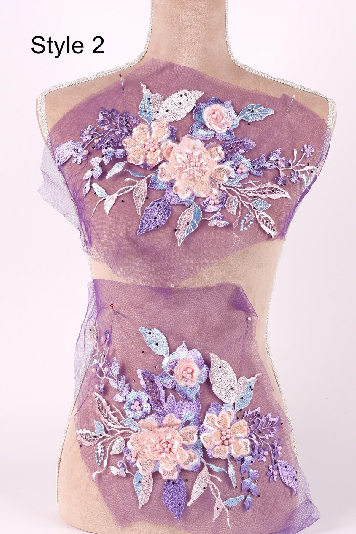A mannequin wearing a purple dress with a floral pattern.