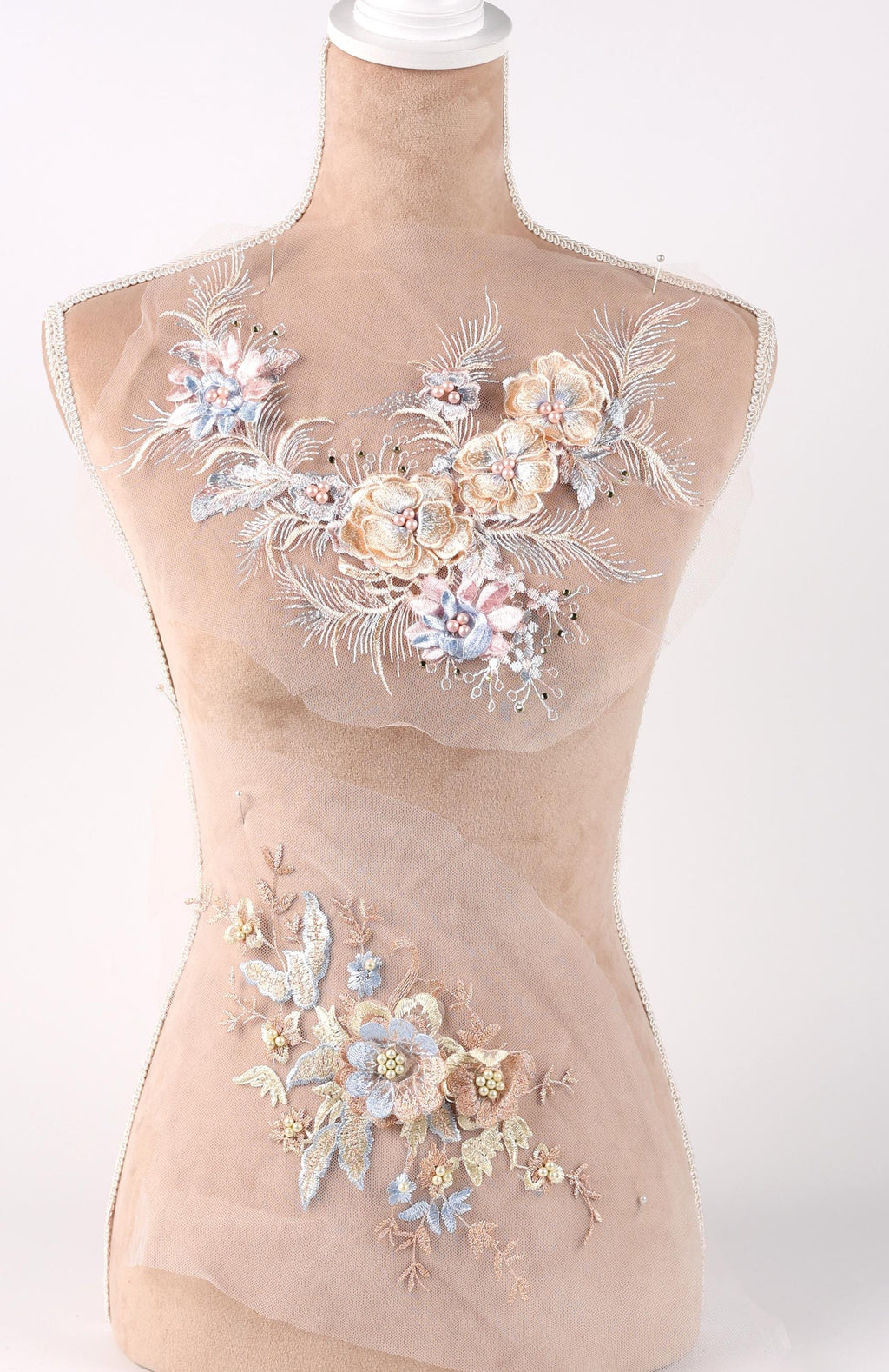 A mannequin with a beige body and a floral design on its chest area.