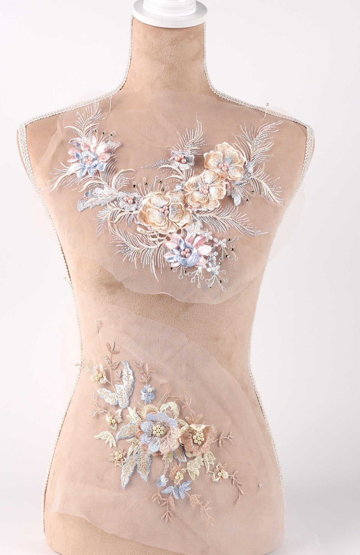 A mannequin with a beige body and a floral design on its chest area.