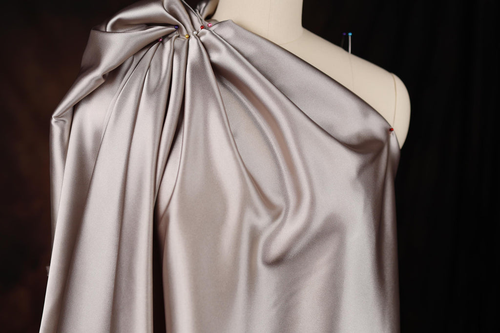 a dress on a mannequin with a bow on it