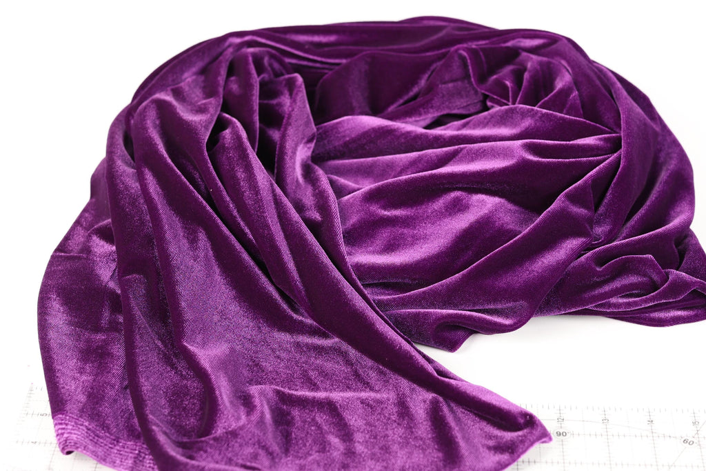 a close-up view of a purple velvet fabric, with its folds and creases visible.