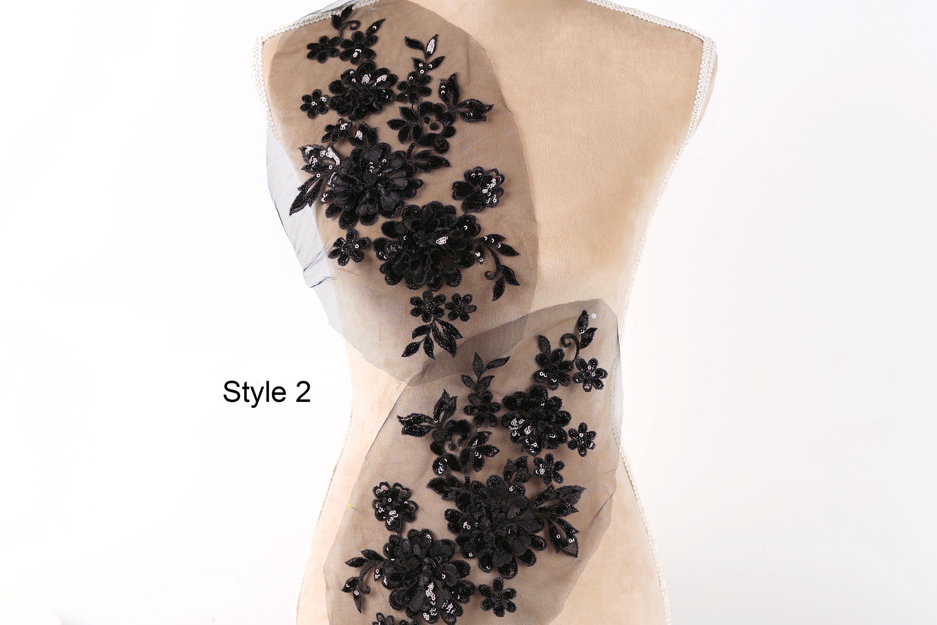 A mannequin with a beige body and a black floral pattern on the back.