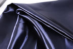 a close-up view of a shiny, dark blue satin fabric.
